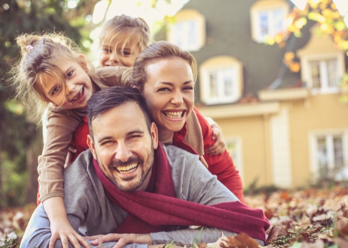 Happy TechniCool customers, family playing in leaves